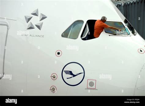 A cleaner is cleaning the cockpit windows of a Airbus A380 from Lufthansa Stock Photo - Alamy