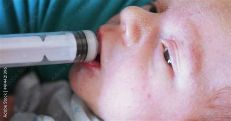 Artificial feeding of the child with a syringe Stock Video | Adobe Stock