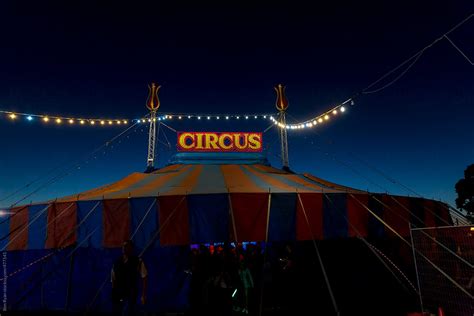 "Exterior View Of Circus Tent With Lights At Dusk" by Stocksy Contributor "Ben Ryan" - Stocksy