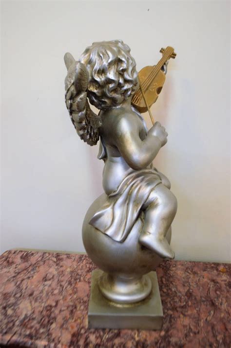 Pair of Silver Ornamental Musician Cherub Sculptures at 1stDibs | ornamental sculptures