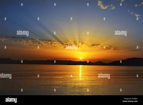 colorful sunsetover the sea in Milos island, Greece Stock Photo - Alamy