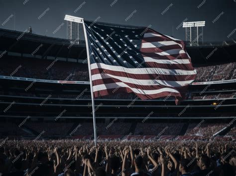 Premium AI Image | A large american flag is in a stadium with a crowd in the background.