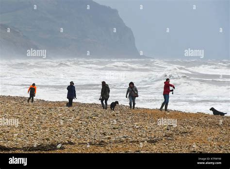 Charmouth, Dorset, UK. 25th December 2017. UK Weather. People out on Charmouth Beach in Dorset ...