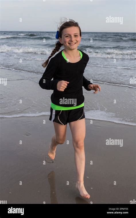 An athletic ten year old girl runs on the sand in Long Beach, NY. She Stock Photo: 82824257 - Alamy