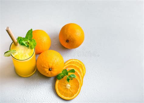 Fresh Orange Juice with Mint and Lime Garnish Set on White Background ...