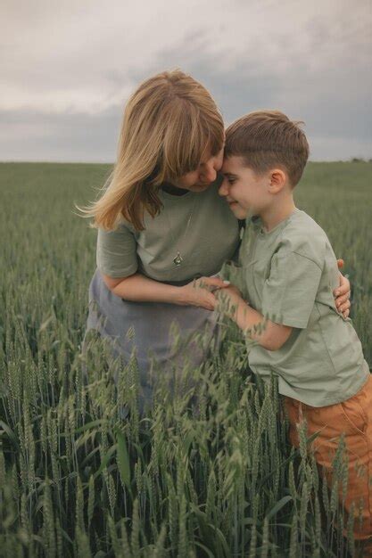 Premium Photo | Portrait of mother and son in the field. hugs and happiness