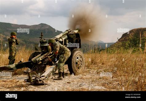 Armed Forces of the Philippines Marines fire an M101 105 mm howitzer during artillery live-fire ...