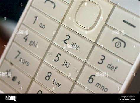 White phone keyboard - old generation. Bright white key with numbers. Keypad for typing messages ...