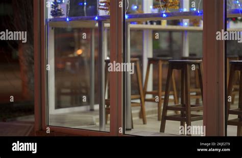 Coffee shop window display with festive lighting at dusk, cafe in the evening Stock Video ...