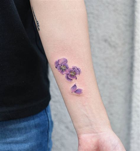 Tiny purple flowers tattoo on the wrist - Tattoogrid.net