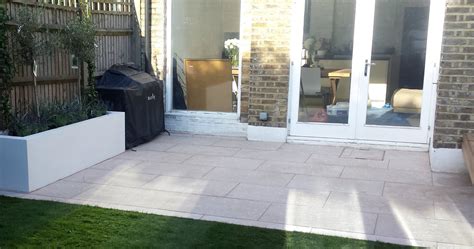 Grey limestone patio paving raised beds floating hardwood bench Clapham London - London Garden ...