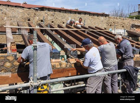 Pompeii Archaeological Site, Campania, Italy. Builders working on a roof. Most roofs in Pompeii ...