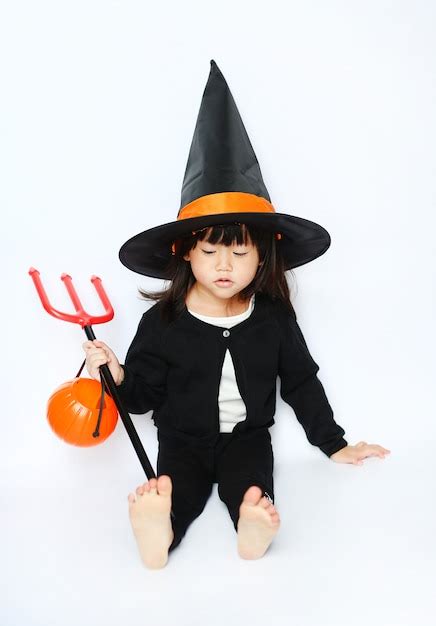 Premium Photo | Adorable little baby halloween witch are sitting