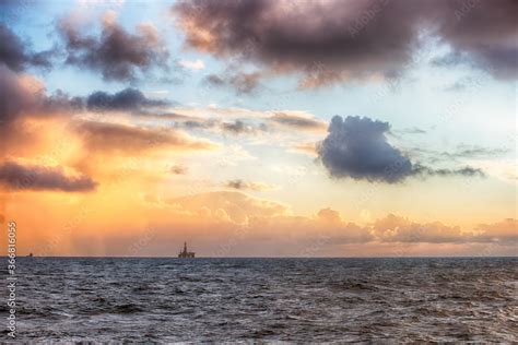 Offshore oil rig at sunset time Stock Photo | Adobe Stock