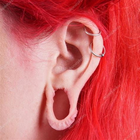 Pics: ear gauges | Stretched ear lobe piercing — Stock Photo © buecax #34388985