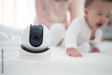 Baby monitor camera with blurred baby background for text space ...