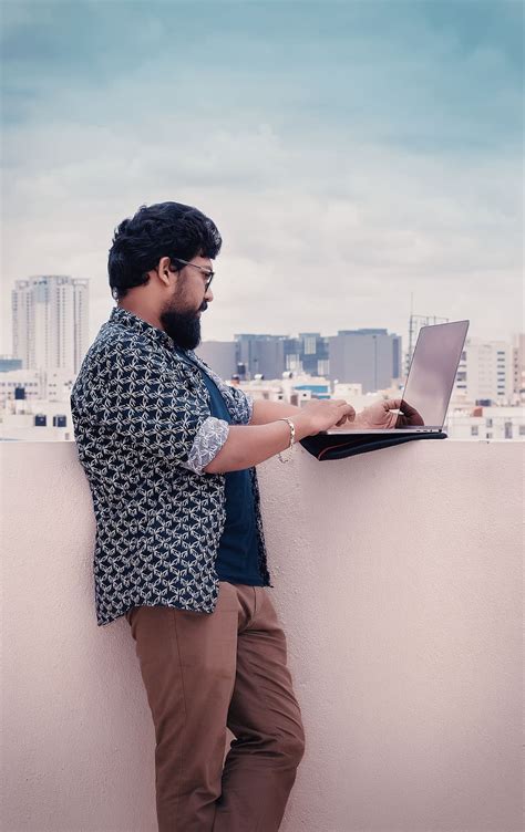 man, standing, beside, white, wall, holding, laptop computer, digital ...