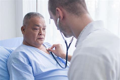 Doctor using stethoscope to listen to patient's heart 1259892 Stock ...