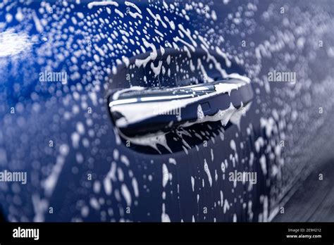 Foam on car body in manual car wash Stock Photo - Alamy