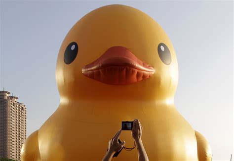 A man takes a picture of the “Rubber Duck” by Dutch conceptual artist Florentijn Hofman at Kaohsiung