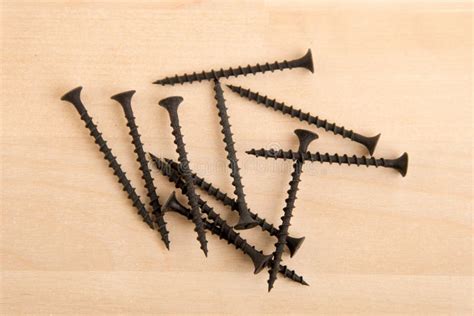 Black Wood Screws on Wooden Background. Stock Photo - Image of materialn, detail: 136176702