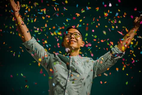 happy person celebrates their accomplishments with colorful confetti ...