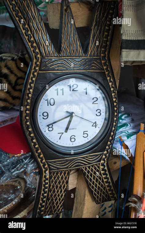 AUGUST 25, 2019-BANAUE IFUGAO, PHILIPPINES : Circular clock placed at the center of a carved ...