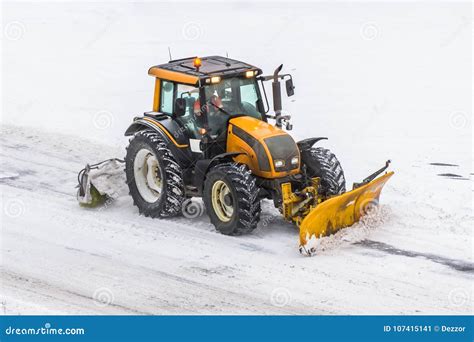 Large Snow Plowing Tractor Machine at Work on the Road during a Snow Storm in Winter. Editorial ...