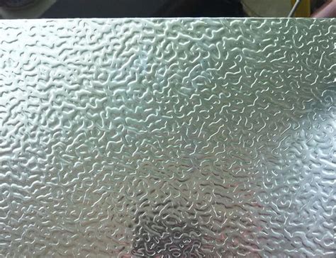 Embossed anodized aluminum plate features