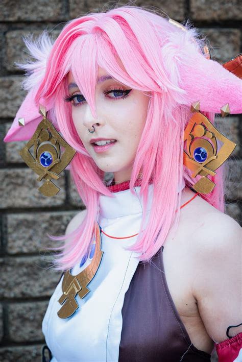 Female Cosplayer in a Pink Anime Costume Wearing Pink Hair Stock Photo ...