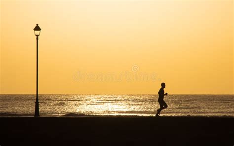 Man Running on Beach Path in Silhouette Stock Image - Image of workout, morning: 242499235