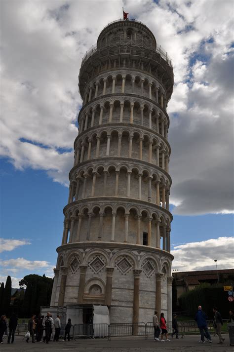 the leaning tower has people walking around it