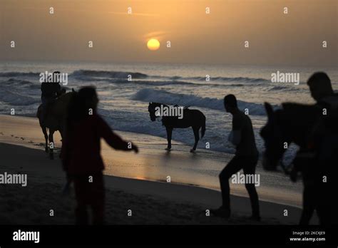 Palestinians enjoy during the sunset on the beach, in Gaza City, Dec ...