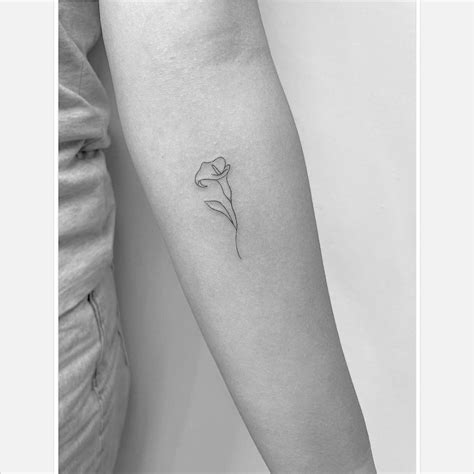 Fine line calla lily flower tattoo on the inner