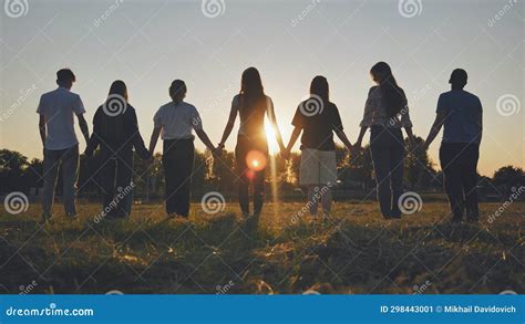 Friends Standing Holding Hands at Sunset. Stock Image - Image of ...