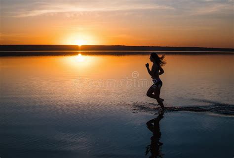 Woman Running on the Beach at Sunset Stock Photo - Image of action ...