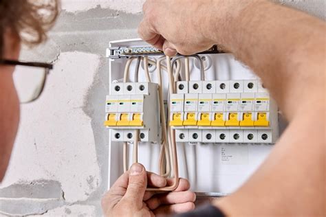 Premium Photo | Connecting home wiring to fuse box in consumer unit of ...