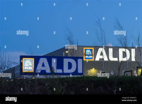 Store logo at night for ALDI supermarket England UK Stock Photo - Alamy