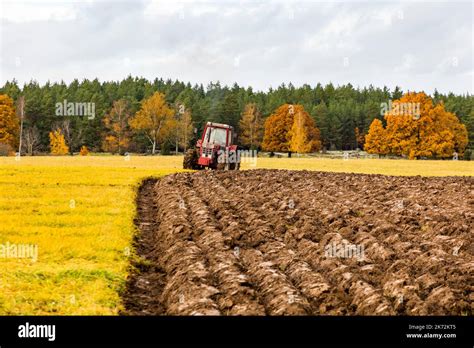 Tractor plowing field Stock Photo - Alamy