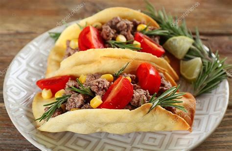 Mexican food Tacos in plate on wooden table, closeup — Stock Photo © belchonock #74140409