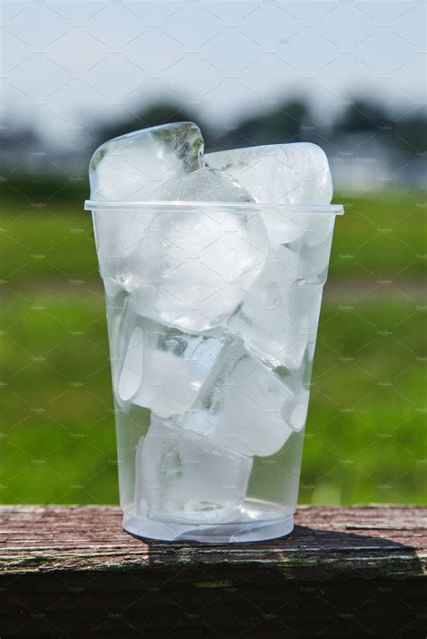 Plastic Cup full of ice outdoor | Food Images ~ Creative Market