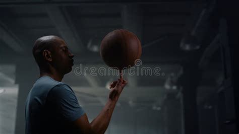 Portrait of Serious Basketball Player Spinning Basketball Ball on ...