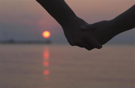 Couple holding hands at sunset 1947050 Stock Photo at Vecteezy