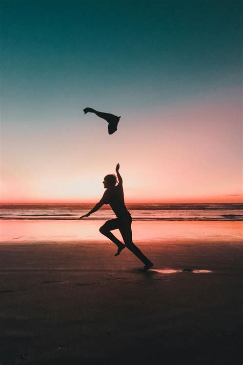 Silhouette of Person Running on Beach during Sunset · Free Stock Photo