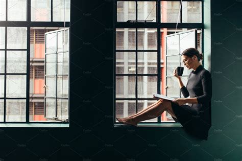 Woman sitting on window sill | High-Quality Beauty & Fashion Stock Photos ~ Creative Market