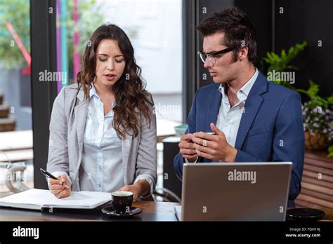 People writing in a notebook Stock Photo - Alamy