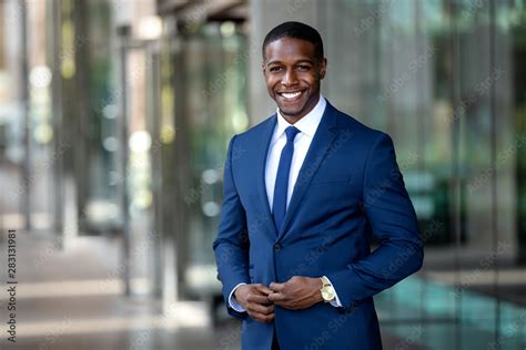 Handsome charming cheerful african american businessman in swanky modern stylish suit and tie ...