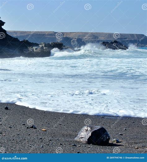 Black rock at the beach stock photo. Image of cliff - 269794746