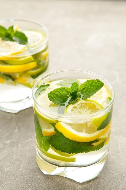 Premium Photo | Water detox with lemon, lime and mint on a grey concrete background