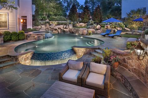 Infinity edge pool with boulder waterfall and spa. | Backyard pool, Pool waterfall, Pool remodel